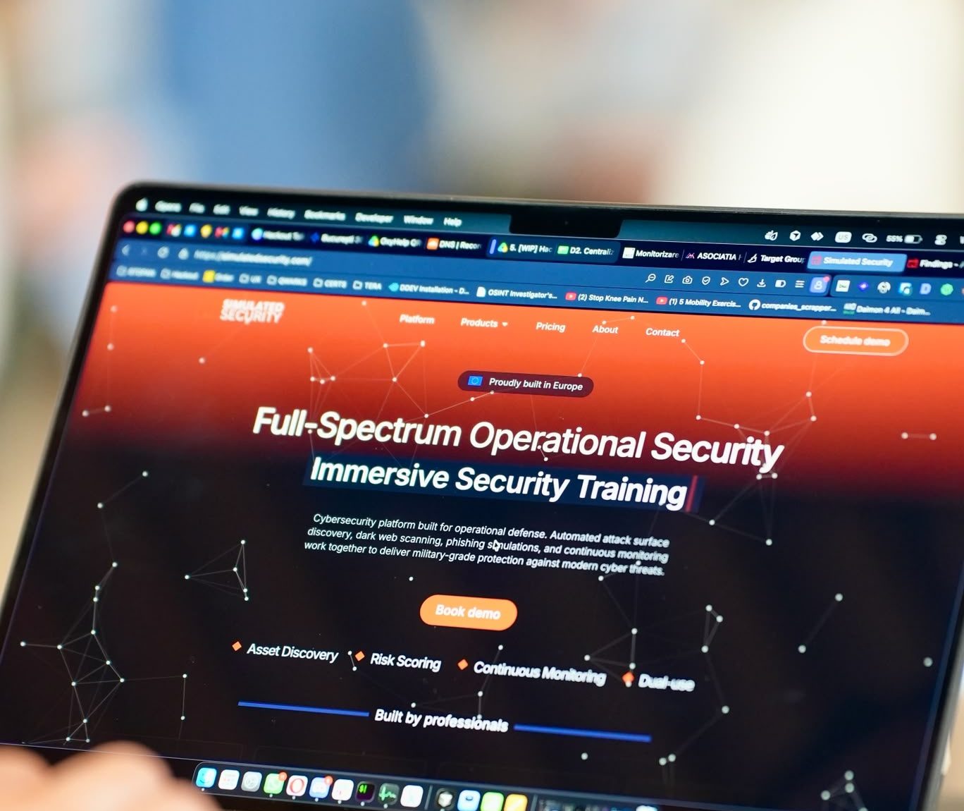 The Simulated Security website on a laptop at an event