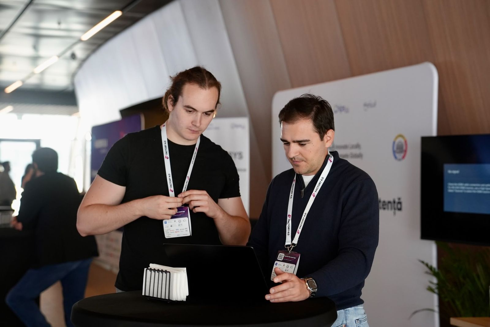 Two team members preparing a demo at the stand